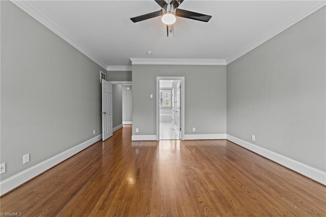 unfurnished bedroom featuring crown molding, ensuite bath, wood-type flooring, and ceiling fan