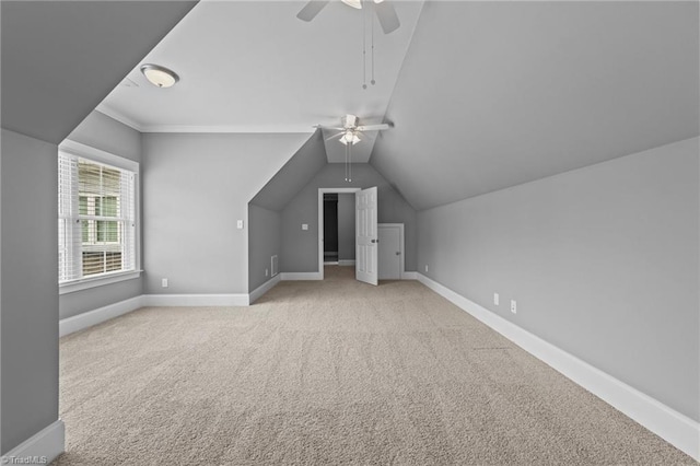 bonus room featuring lofted ceiling, light carpet, and ceiling fan