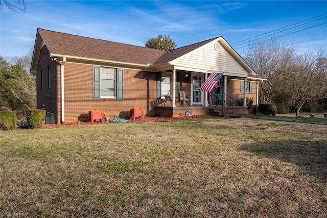 bungalow-style house featuring a porch, a front yard, brick siding, and a shingled roof