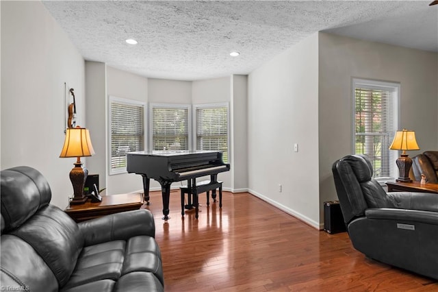 home office featuring wood-type flooring and a textured ceiling