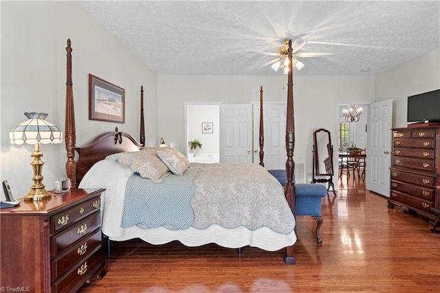 bedroom with ceiling fan, a textured ceiling, and hardwood / wood-style flooring