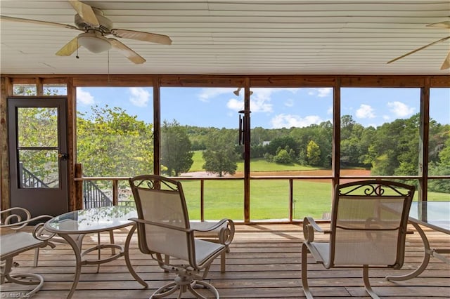 sunroom featuring ceiling fan and a healthy amount of sunlight