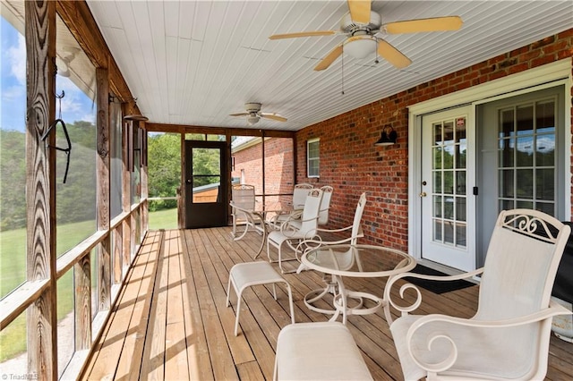 unfurnished sunroom with ceiling fan and wood ceiling