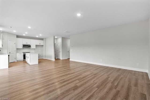 unfurnished living room with light hardwood / wood-style flooring