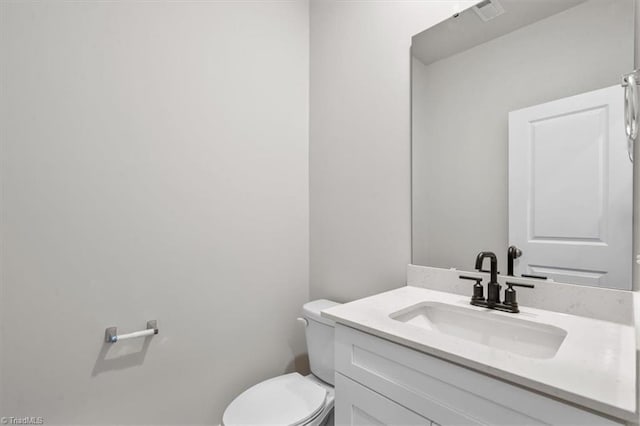 bathroom with toilet and vanity