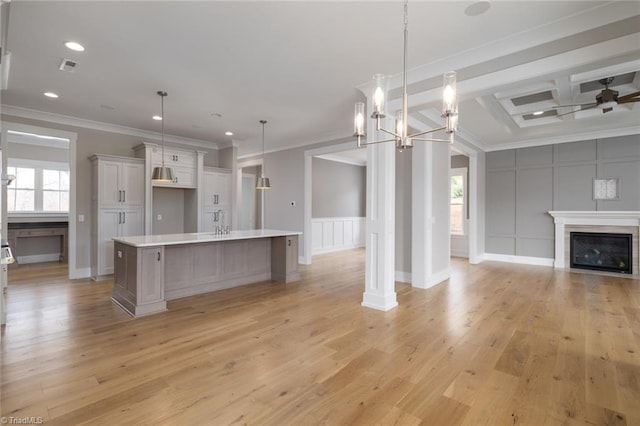 kitchen with plenty of natural light, open floor plan, light countertops, and a decorative wall