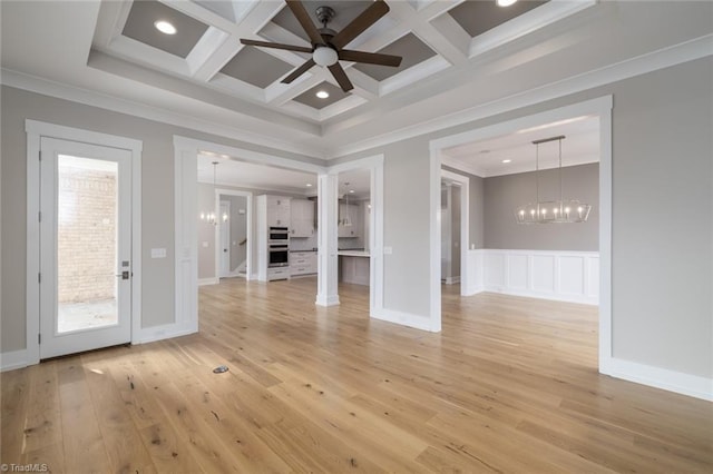 unfurnished living room featuring crown molding, beamed ceiling, light wood-type flooring, ceiling fan with notable chandelier, and coffered ceiling