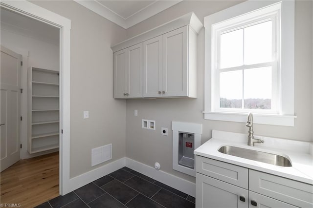 laundry area with visible vents, washer hookup, cabinet space, electric dryer hookup, and a sink