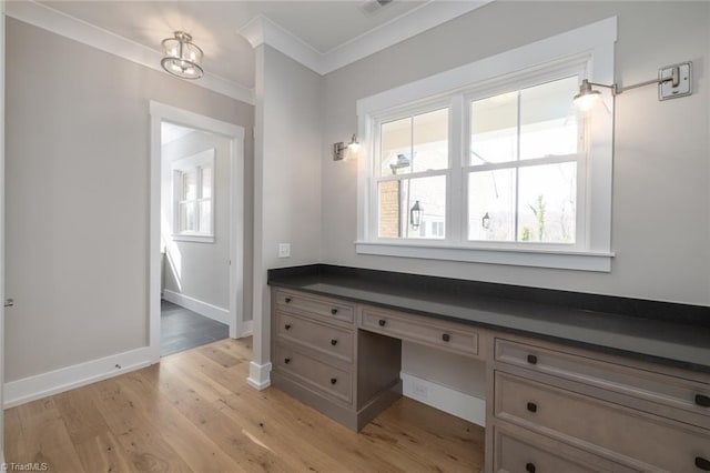 bathroom with visible vents, crown molding, baseboards, and wood finished floors