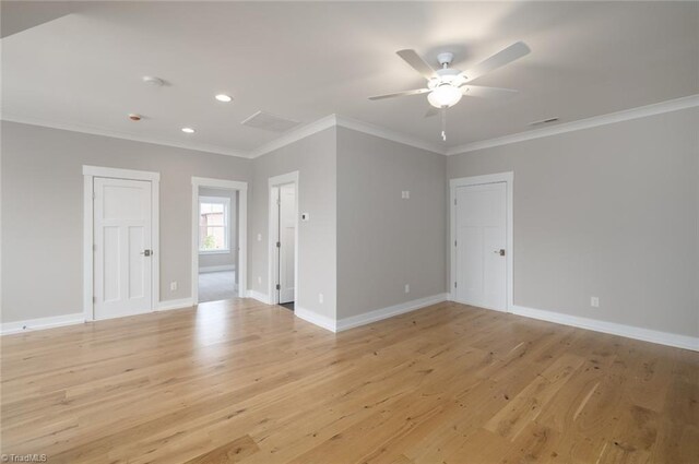 spare room with light wood-type flooring, a ceiling fan, and crown molding