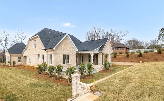 view of side of home featuring a yard and brick siding