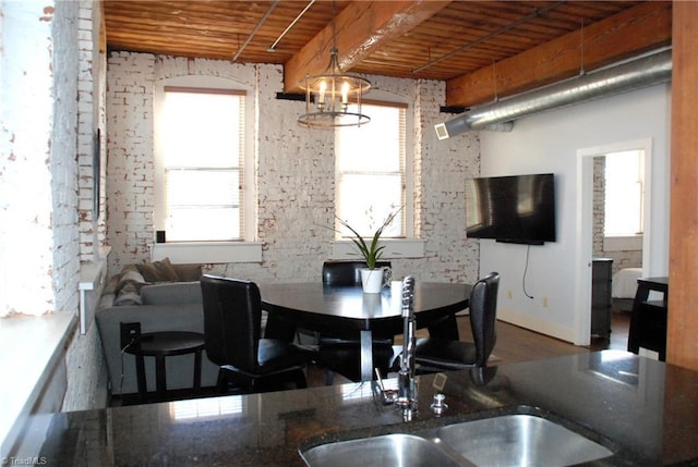 dining space featuring a chandelier, wooden ceiling, and wood finished floors