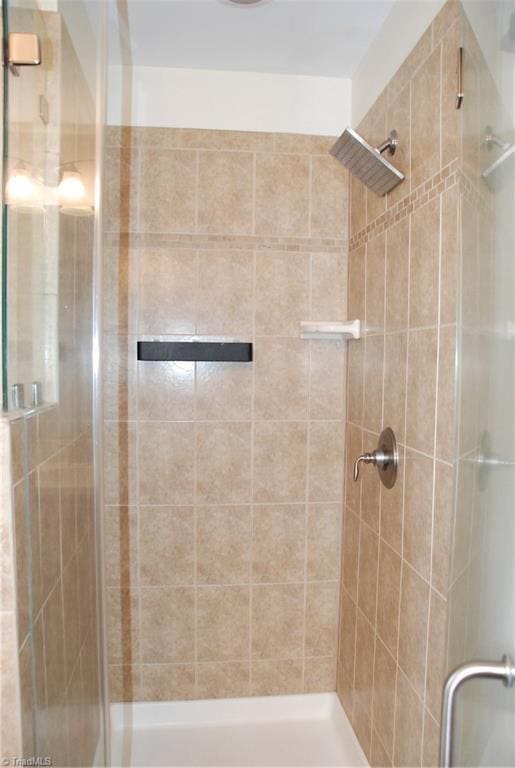 full bath with a shower stall