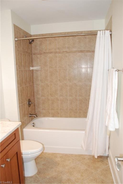 full bathroom with tile patterned flooring, vanity, toilet, and shower / bath combo with shower curtain