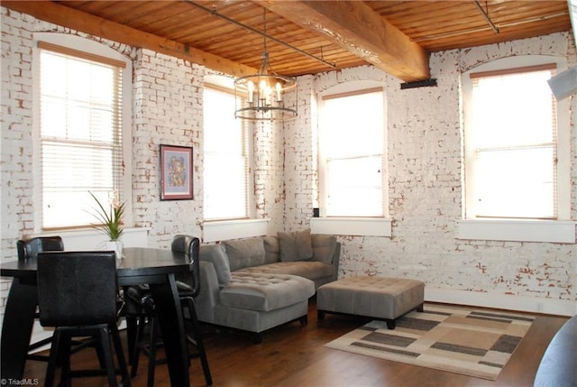 interior space featuring wooden ceiling, beam ceiling, a wealth of natural light, and wood finished floors