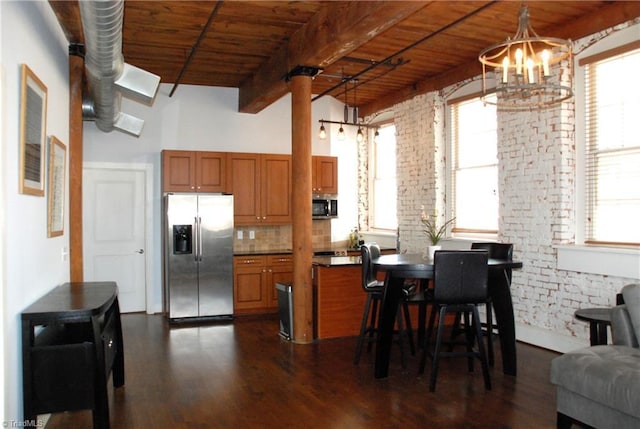 kitchen featuring dark wood-style floors, brown cabinets, stainless steel appliances, wooden ceiling, and beamed ceiling