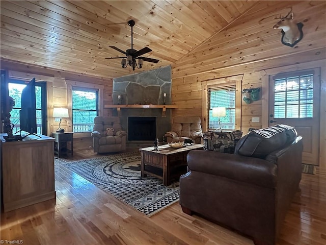 45 Wedgewood Ridge Ln, Fancy Gap, VA 24328 - living room with wood finished floors, wood walls, wood ceiling, ceiling fan, and a fireplace