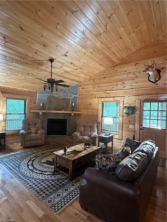 45 Wedgewood Ridge Ln, Fancy Gap, VA 24328 - living area featuring vaulted ceiling, wood walls, a ceiling fan, wood finished floors, and a fireplace