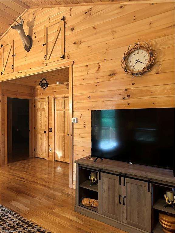 45 Wedgewood Ridge Ln, Fancy Gap, VA 24328 - living area with wood walls, vaulted ceiling, wood finished floors, and wood ceiling