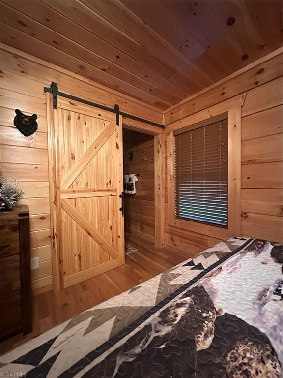 45 Wedgewood Ridge Ln, Fancy Gap, VA 24328 - bedroom featuring wooden walls, wood finished floors, a barn door, and wooden ceiling