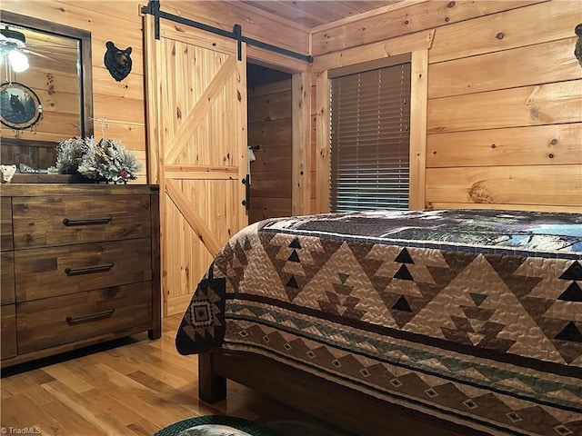 45 Wedgewood Ridge Ln, Fancy Gap, VA 24328 - bedroom featuring wood finished floors, wood walls, and a barn door