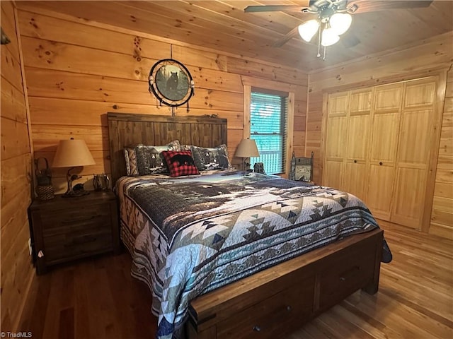 45 Wedgewood Ridge Ln, Fancy Gap, VA 24328 - bedroom with wood finished floors, wooden walls, ceiling fan, and a closet