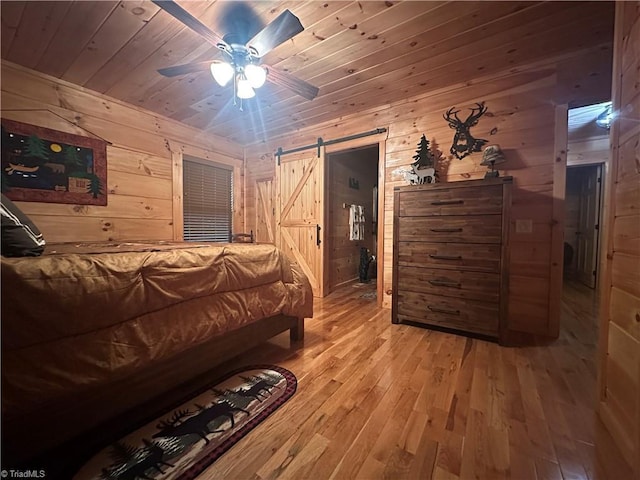 45 Wedgewood Ridge Ln, Fancy Gap, VA 24328 - bedroom featuring wooden walls, a barn door, wooden ceiling, hardwood / wood-style flooring, and a ceiling fan