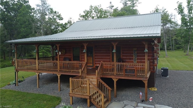 45 Wedgewood Ridge Ln, Fancy Gap, VA 24328 - view of front of property featuring a porch, a front lawn, central AC unit, metal roof, and log siding