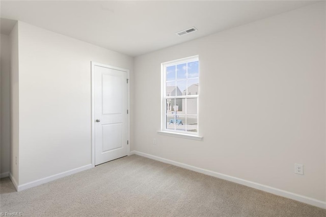 unfurnished room with light colored carpet