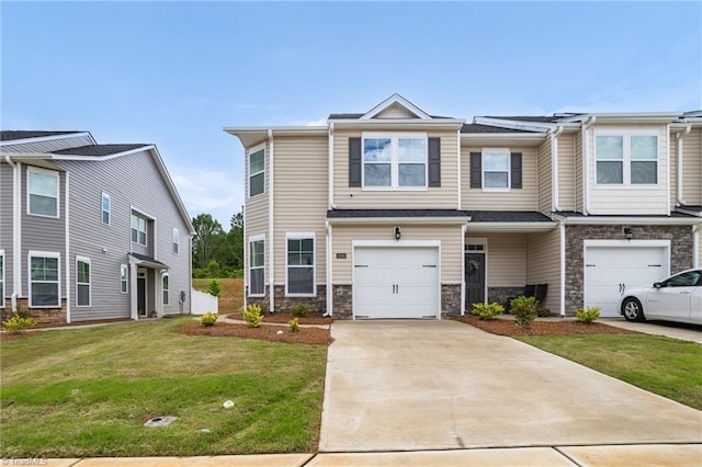 1230 Evelynnview Ln, Kernersville, NC 27284 - townhome / multi-family property featuring an attached garage, concrete driveway, a front lawn, and stone siding
