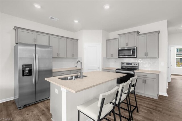 1230 Evelynnview Ln, Kernersville, NC 27284 - kitchen featuring appliances with stainless steel finishes, gray cabinets, a sink, dark wood-style floors, and recessed lighting