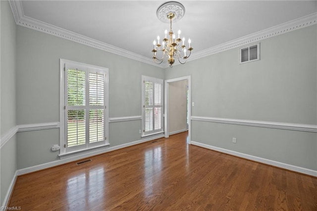 1400 Covered Wagon Rd, Mcleansville, NC 27301 - unfurnished room featuring a chandelier, baseboards, wood finished floors, and crown molding
