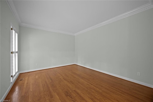 1400 Covered Wagon Rd, Mcleansville, NC 27301 - spare room featuring wood finished floors, ornamental molding, and baseboards