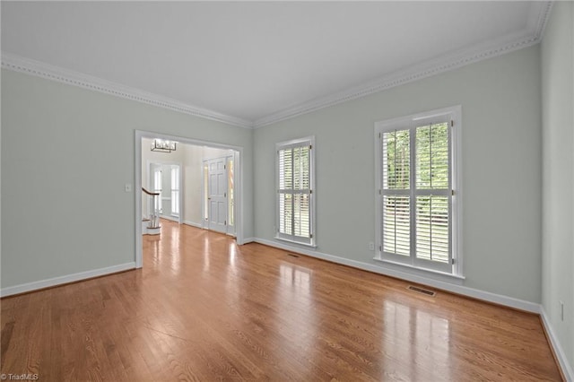 1400 Covered Wagon Rd, Mcleansville, NC 27301 - unfurnished room with ornamental molding, wood finished floors, baseboards, and a chandelier
