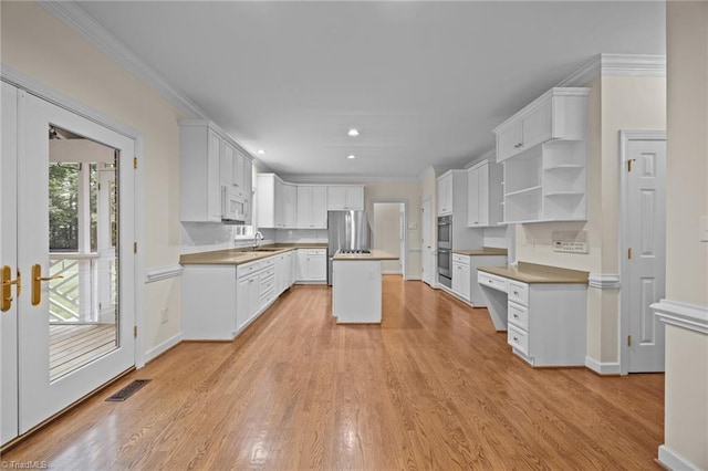 1400 Covered Wagon Rd, Mcleansville, NC 27301 - kitchen featuring stainless steel appliances, recessed lighting, light wood-style floors, a kitchen island, and white cabinetry