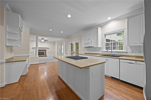 1400 Covered Wagon Rd, Mcleansville, NC 27301 - kitchen with white appliances, open floor plan, a sink, open shelves, and crown molding
