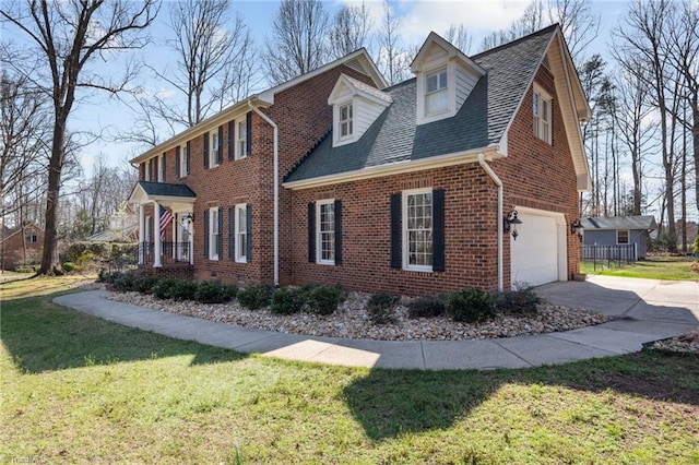 1400 Covered Wagon Rd, Mcleansville, NC 27301 - view of home's exterior featuring brick siding, a garage, concrete driveway, a lawn, and a shingled roof