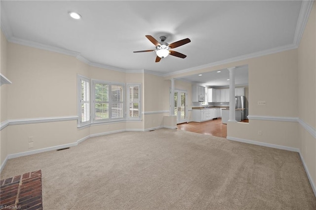 1400 Covered Wagon Rd, Mcleansville, NC 27301 - unfurnished living room featuring light colored carpet, a ceiling fan, baseboards, ornamental molding, and recessed lighting