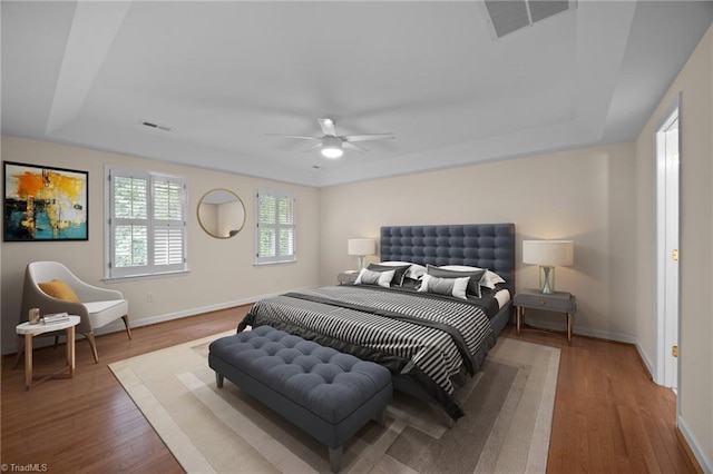 1400 Covered Wagon Rd, Mcleansville, NC 27301 - bedroom with a tray ceiling, baseboards, and wood finished floors