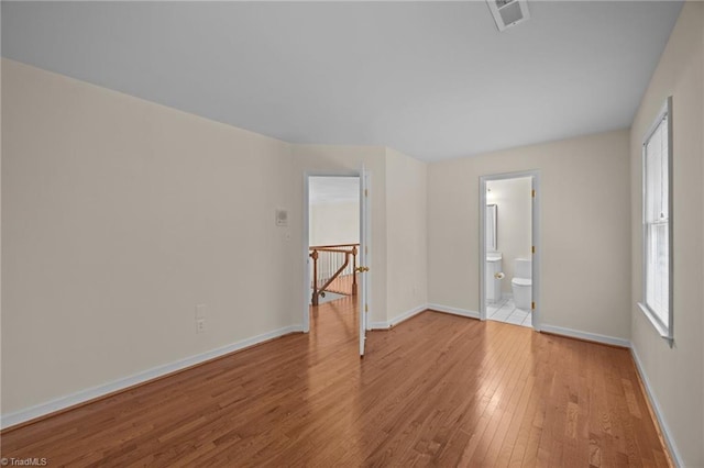1400 Covered Wagon Rd, Mcleansville, NC 27301 - spare room with wood-type flooring and baseboards