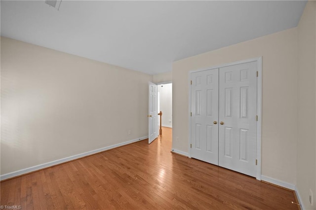 1400 Covered Wagon Rd, Mcleansville, NC 27301 - unfurnished bedroom featuring wood finished floors, baseboards, and a closet