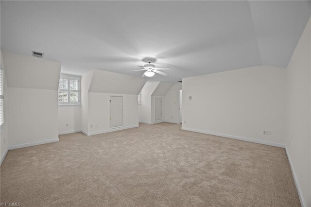 1400 Covered Wagon Rd, Mcleansville, NC 27301 - additional living space with light colored carpet, lofted ceiling, ceiling fan, and baseboards