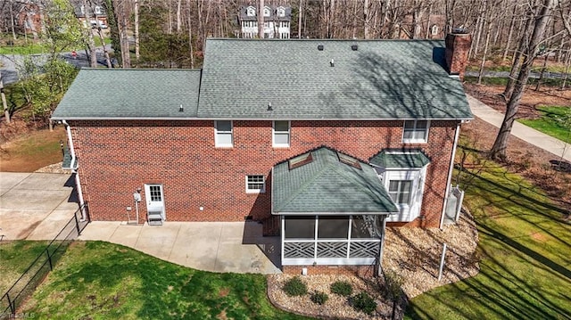 1400 Covered Wagon Rd, Mcleansville, NC 27301 - rear view of property with a sunroom, a shingled roof, a patio area, and a chimney