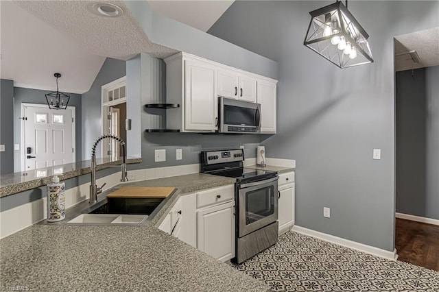 kitchen featuring a sink, baseboards, appliances with stainless steel finishes, and white cabinets