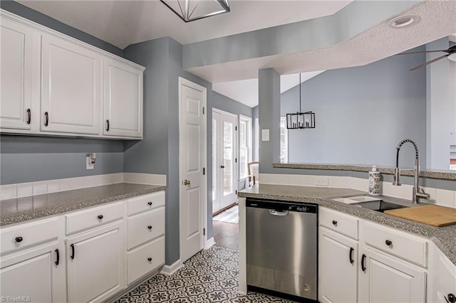 kitchen with decorative light fixtures, dishwasher, ceiling fan with notable chandelier, white cabinets, and a sink