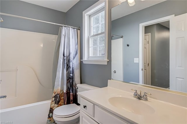 bathroom featuring shower / tub combo with curtain, toilet, and vanity