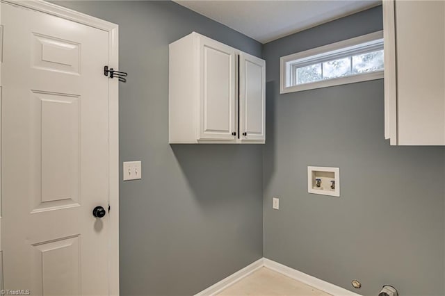 laundry room featuring hookup for a washing machine, cabinet space, and baseboards