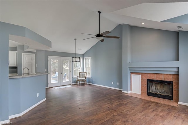 unfurnished living room featuring visible vents, a sink, dark wood finished floors, french doors, and ceiling fan