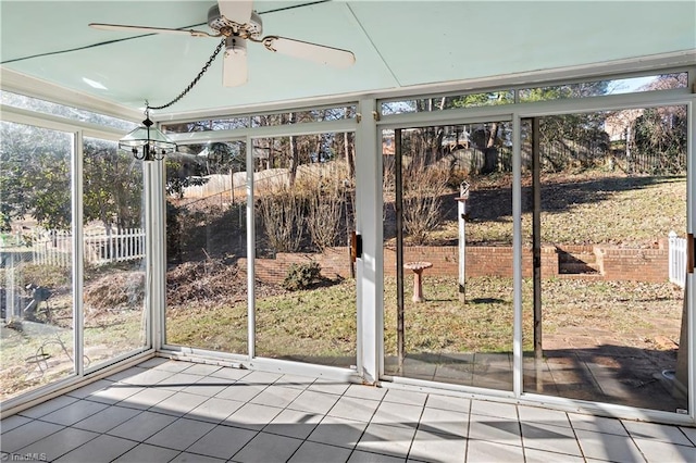 unfurnished sunroom with ceiling fan