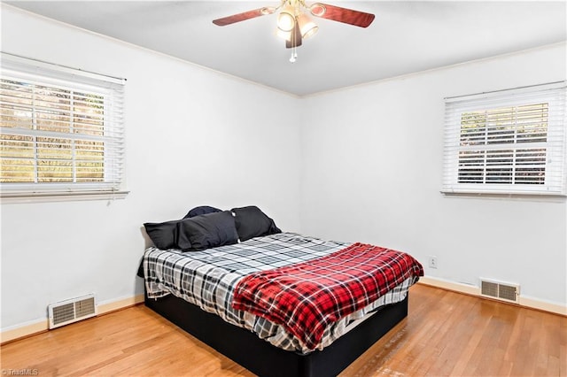 bedroom with hardwood / wood-style flooring and ceiling fan